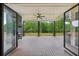 Spacious covered patio boasts a ceiling fan, stone fireplace, and wooded backyard views at 1255 E M Croy Rd, Sugar Hill, GA 30518