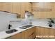 Functional prep kitchen featuring a modern electric cooktop and range hood vented to the outside at 1255 E M Croy Rd, Sugar Hill, GA 30518