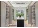 The large walk-in closet has an island for accessories, custom shelving, and jewelry drawers at 1255 E M Croy Rd, Sugar Hill, GA 30518