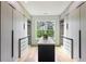 A large walk-in closet with custom shelving and an island for organizing clothing and accessories at 1255 E M Croy Rd, Sugar Hill, GA 30518