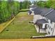 Aerial view showing home with large backyard surrounded by mature trees and a wood fence at 1255 E M Croy Rd, Sugar Hill, GA 30518