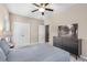 Neutral bedroom featuring a ceiling fan, double door closet, and a black dresser with modern decor at 1370 Dupont Nw Park, Atlanta, GA 30318