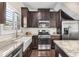 Well-equipped kitchen featuring granite counters, stainless steel appliances and dark wood cabinetry at 1370 Dupont Nw Park, Atlanta, GA 30318