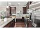 Well-equipped kitchen features a farmhouse sink, stainless steel appliances, and dark wood cabinetry at 1370 Dupont Nw Park, Atlanta, GA 30318