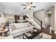 Open concept living room with hardwood floors, ceiling fan, and seamless transition to the dining and kitchen areas at 1370 Dupont Nw Park, Atlanta, GA 30318