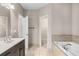 Elegant main bathroom featuring dual sinks, soaking tub, and access to a walk-in closet at 1370 Dupont Nw Park, Atlanta, GA 30318
