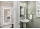 Stylish powder room with pedestal sink and elegant fixtures at 1370 Dupont Nw Park, Atlanta, GA 30318