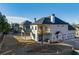 Aerial view of the backyard featuring white brick house, covered patio, balcony and three car garage at 4281 Sierra Creek Ct, Hoschton, GA 30548
