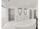 Bathroom featuring a soaking tub, dual vanity, and a connecting door at 4281 Sierra Creek Ct, Hoschton, GA 30548