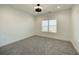 A standard bedroom with gray carpet and a window at 4281 Sierra Creek Ct, Hoschton, GA 30548