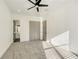 Bright bedroom with gray carpet, ceiling fan, and ensuite bathroom at 4281 Sierra Creek Ct, Hoschton, GA 30548
