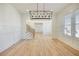 Inviting dining room features modern lighting, hardwood floors, and elegant finishes, creating a warm atmosphere at 4281 Sierra Creek Ct, Hoschton, GA 30548