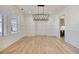 Bright dining room with hardwood floors, wainscoting, and a modern chandelier, perfect for entertaining at 4281 Sierra Creek Ct, Hoschton, GA 30548