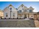 Striking two-story home boasts a brick facade, inviting porch, and well-manicured lawn at 4281 Sierra Creek Ct, Hoschton, GA 30548
