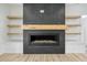 Close up of fireplace with tile surround and floating shelves at 4281 Sierra Creek Ct, Hoschton, GA 30548