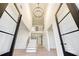 Grand foyer features soaring ceilings, a modern chandelier, and an open staircase with wood treads at 4281 Sierra Creek Ct, Hoschton, GA 30548