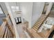 Spacious foyer featuring hardwood floors, a modern chandelier, and a staircase at 4281 Sierra Creek Ct, Hoschton, GA 30548