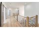 Well-lit upstairs hallway features hardwood floors and barn-style doors at 4281 Sierra Creek Ct, Hoschton, GA 30548