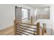 Upstairs hallway with hardwood floors and modern black metal railing at 4281 Sierra Creek Ct, Hoschton, GA 30548