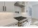 Modern kitchen features stainless steel appliances, a gas range, and herringbone tile backsplash at 4281 Sierra Creek Ct, Hoschton, GA 30548