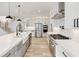 Spacious eat-in kitchen has stainless appliances, oversized island, and sleek white cabinets at 4281 Sierra Creek Ct, Hoschton, GA 30548