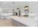 Beautiful kitchen with large island, modern appliances, and custom lighting at 4281 Sierra Creek Ct, Hoschton, GA 30548