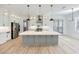Gourmet kitchen featuring a large island, stainless steel appliances, and custom cabinetry at 4281 Sierra Creek Ct, Hoschton, GA 30548