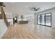 Open-concept living space with hardwood floors and large sliding glass doors at 4281 Sierra Creek Ct, Hoschton, GA 30548