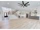 Open-concept living space with hardwood floors, chef's kitchen, and modern staircase at 4281 Sierra Creek Ct, Hoschton, GA 30548