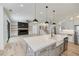 Open-concept kitchen and living area with hardwood floors, fireplace, and staircase at 4281 Sierra Creek Ct, Hoschton, GA 30548