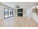 Spacious living room with modern fireplace, hardwood floors, and natural light at 4281 Sierra Creek Ct, Hoschton, GA 30548