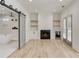 The primary bedroom features a fireplace, shelving, light wood floors, and a bathroom with soaking tub at 4281 Sierra Creek Ct, Hoschton, GA 30548