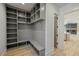 Mudroom features built-in shelving and hooks, adjacent to the kitchen at 4281 Sierra Creek Ct, Hoschton, GA 30548