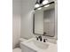 Modern powder room featuring stylish vanity, elegant mirror, and sleek fixtures, adding a touch of sophistication at 4281 Sierra Creek Ct, Hoschton, GA 30548