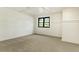 Spacious carpeted bedroom featuring a window, and crisp white walls at 706 Barrington Hills Dr, Atlanta, GA 30350