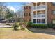 Exterior building view with grassy yard, mature trees, and screened in porch at 706 Barrington Hills Dr, Atlanta, GA 30350