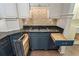 Kitchen features custom blue cabinets, a cooktop, and smart storage solutions for culinary enthusiasts at 706 Barrington Hills Dr, Atlanta, GA 30350