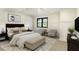 Well-lit main bedroom with a window and stylish décor. Seating for two at 706 Barrington Hills Dr, Atlanta, GA 30350