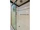 Tile shower with glass doors and overhead shower head at 706 Barrington Hills Dr, Atlanta, GA 30350