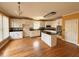 Eat-in kitchen with an island, hardwood floors, stainless steel appliances and white cabinetry at 2105 Ector Nw Cv, Kennesaw, GA 30152