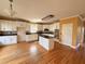 Bright kitchen with a center island, white cabinets, stainless appliances, and hardwood flooring at 2105 Ector Nw Cv, Kennesaw, GA 30152