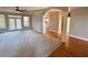 Spacious living room with hardwood accents, ceiling fan and archway to the kitchen at 2105 Ector Nw Cv, Kennesaw, GA 30152