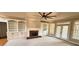 Living area with built-in bookcases, fireplace, and natural light from the patio doors at 2105 Ector Nw Cv, Kennesaw, GA 30152