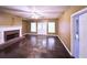 Living room featuring a fireplace, stone flooring, neutral walls, and ample natural light at 2105 Ector Nw Cv, Kennesaw, GA 30152