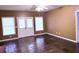 Spacious living room with stone tile flooring, white trim, ceiling fan and plentiful natural light at 2105 Ector Nw Cv, Kennesaw, GA 30152