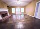 Large living room with fireplace, stone flooring, ceiling fan and direct access to back deck at 2105 Ector Nw Cv, Kennesaw, GA 30152