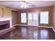 This cozy living room features a white fireplace, stone flooring, and bright windows at 2105 Ector Nw Cv, Kennesaw, GA 30152