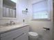 Modern bathroom with granite countertop, a sleek sink, and a tiled shower at 5235 Pounds S Dr, Stone Mountain, GA 30087