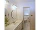 Bright bathroom featuring a vanity with cabinets, a decorative mirror and tiled floors at 5235 Pounds S Dr, Stone Mountain, GA 30087