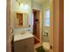 Light blue bathroom featuring a vanity with mirror and a separate toilet area at 5235 Pounds S Dr, Stone Mountain, GA 30087